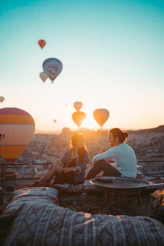 Dating a Younger Partner: Does Age Matters? 3 Couple Sitting on Rooftop During Sunset